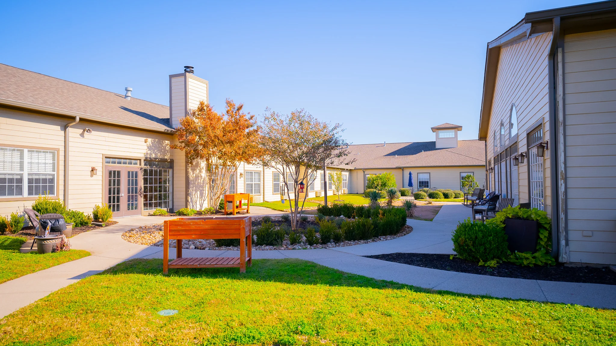 a building with a lawn and a bench