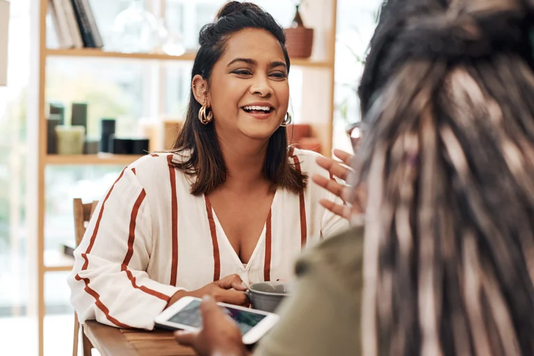 a woman smiles at a therapist during fentanyl addiction treatment