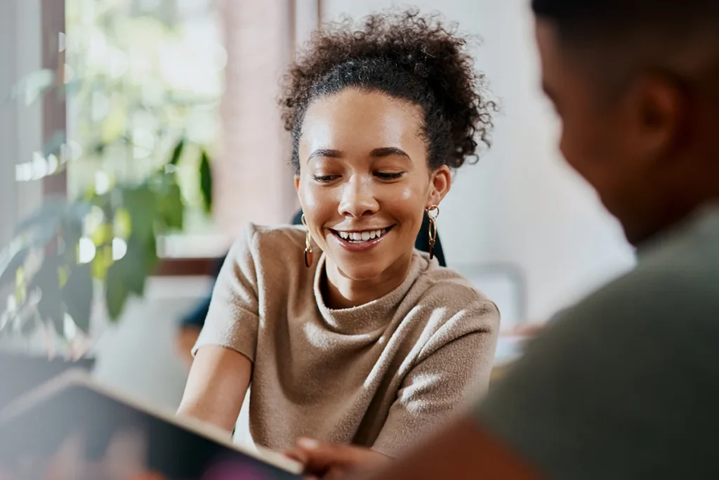 Smiling woman talking with a counselor about treatment options